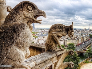 Notre Dame tower gargoyles admired at Paris of France on summer 2011. Eiffel tower and other Paris sightseeings can be found in this picture.