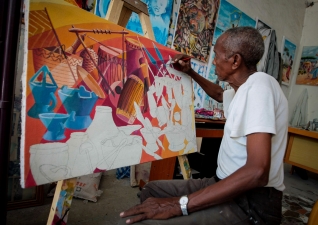 SOMALIA, Mogadishu: In a photograph taken 15 January and released by the African Union-United Nations Information Support Team 21 January, a Somali artist works in the Centre for Research and Dialogue (CRD) art studio in the Wadajir District of the Somali capital Mogadishu. During the occupation of the city by the Al-Qaeda-affiliated militant group Al Shabaab up until August 2011, many Somali artists were either forced to work in secret or stop practising their art all together for fear of retribution and punishment by the extremist group who were fighting to overthrow the internationally-recognised then transitional government and implement a strict and harsh interpretation of Islamic Sharia law. After 20 years of near-constant conflict, Mogadishu and large areas of Somalia are now enjoying the longest period of peace in years after sustained military operations by the Somali National Army (SNA) backed by the forces of the African Union Mission in Somalia (AMISOM) forced Al Shabaab to retreat from many areas of the country precipitating something of a renaissance for Somali artists and business, commerce, sports and civil liberties and freedoms flourishing once again. AU-UN IST PHOTO / STUART PRICE.